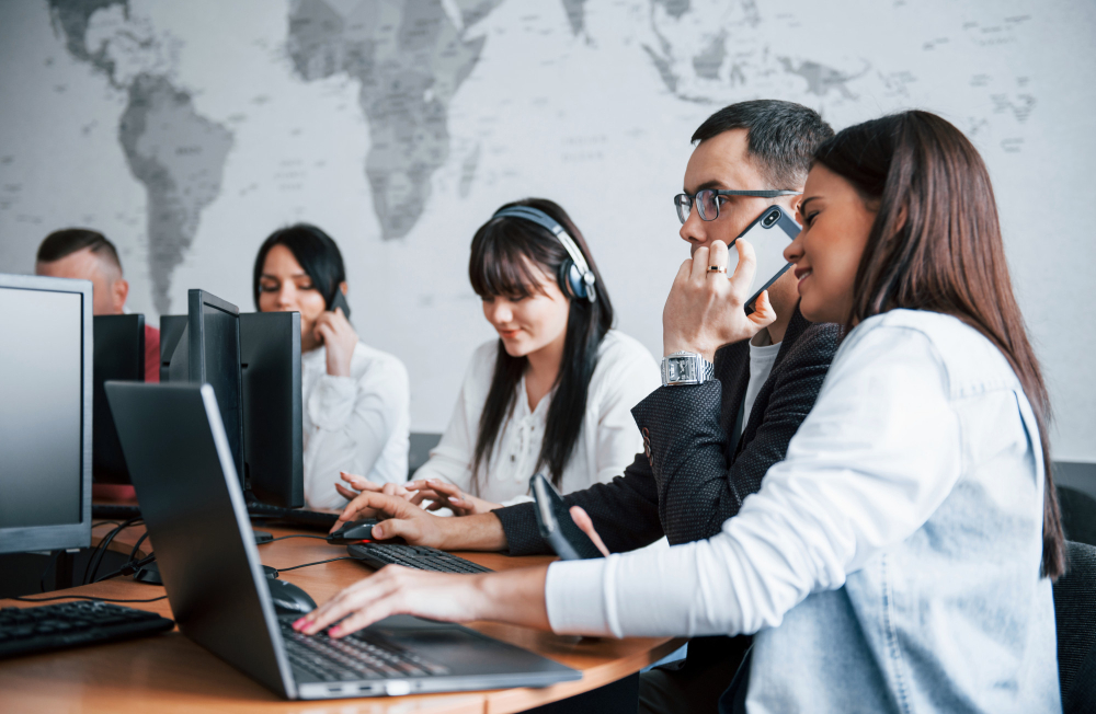 Photo of a group of professionals having a discussion in an office.