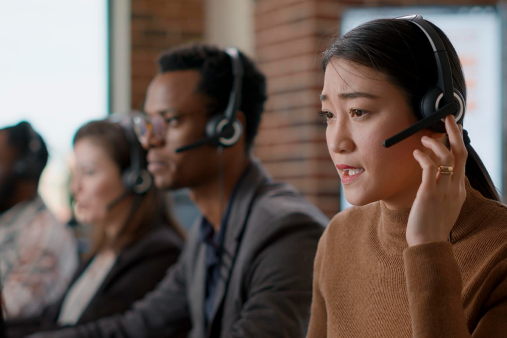 Photo of two call center agents wearing headsets in an office.