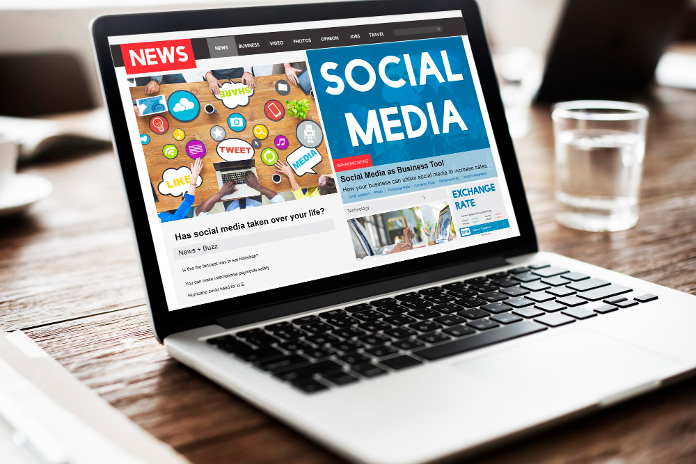 Laptop screen displaying a colorful "Social Media" collage.