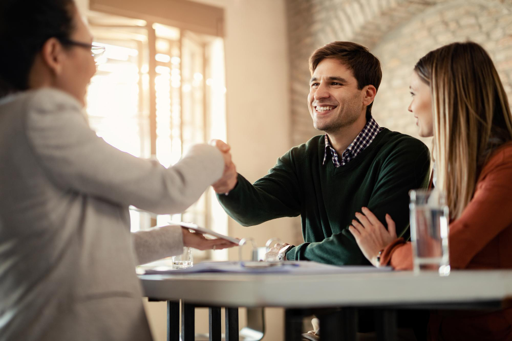 A professional handshake between an Altselino specialist and a client in a bright office.