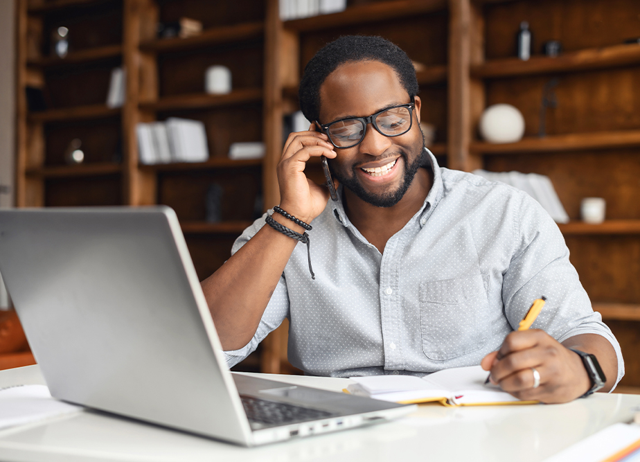 A professional Altselino specialist engaged in an executive call while working on a laptop.